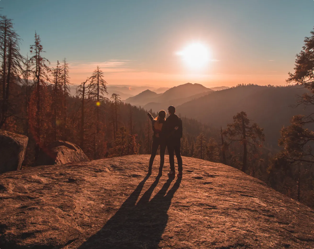 A couple on top of mountain during sunset